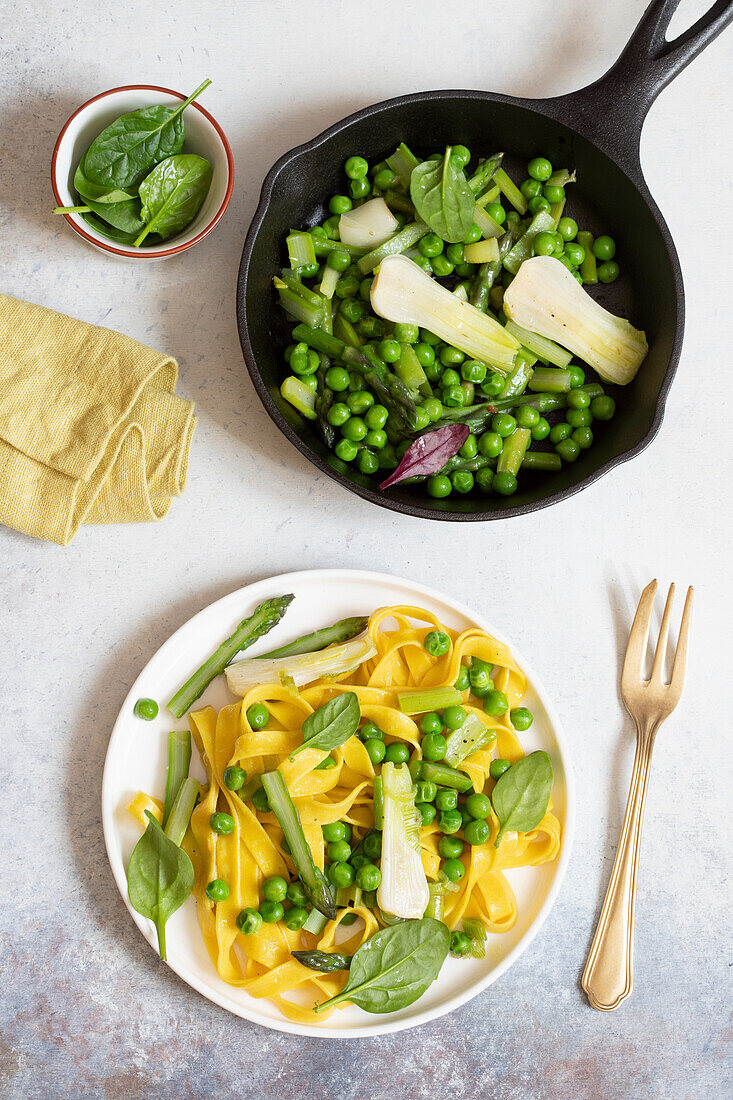 Handmade tagliatelle with asparagus, peas and spring onions