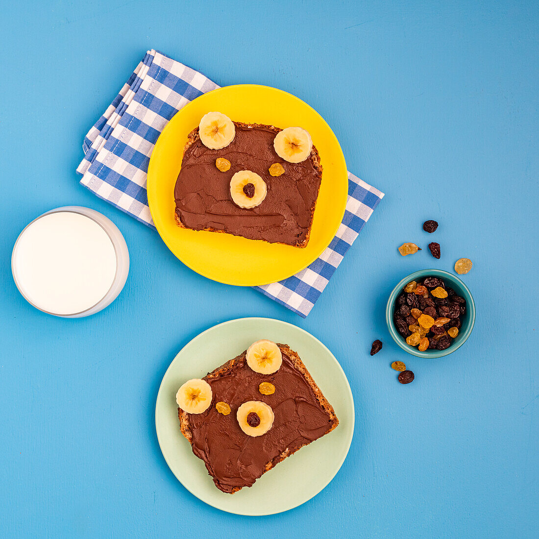 Sandwiches with Nutella, decorated with banana, sultanas and sultanas