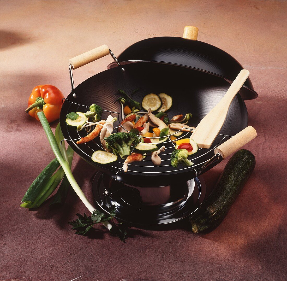 A wok with pieces of vegetables and meat