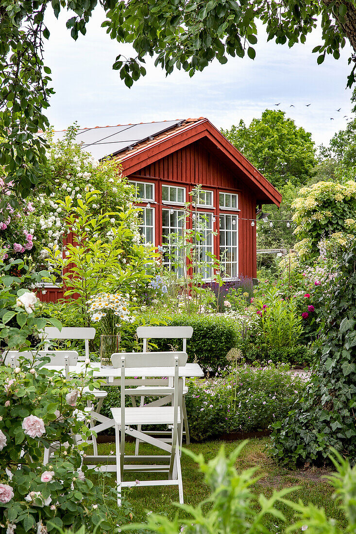 Seating area with table, orangery in the background