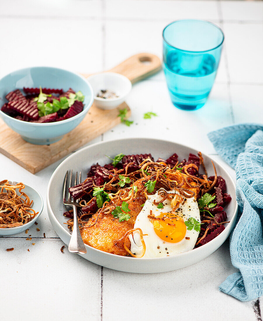 Schnitzel with fried egg and beetroot salad