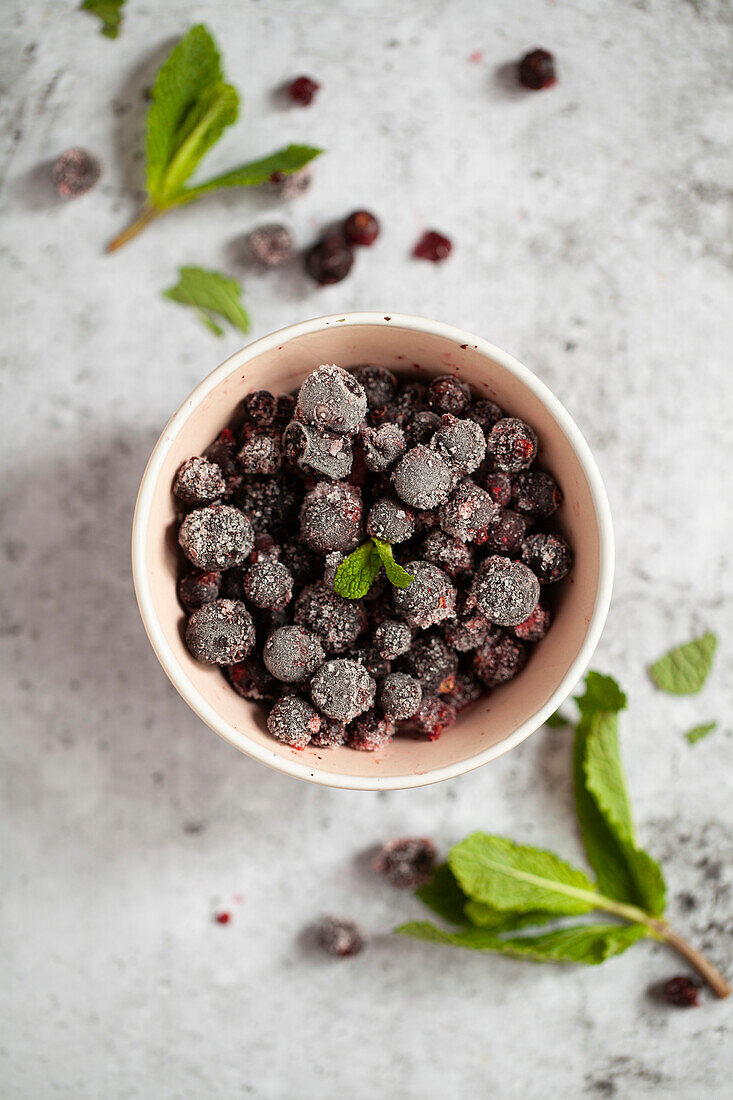 Frozen blackcurrants with fresh mint leaves