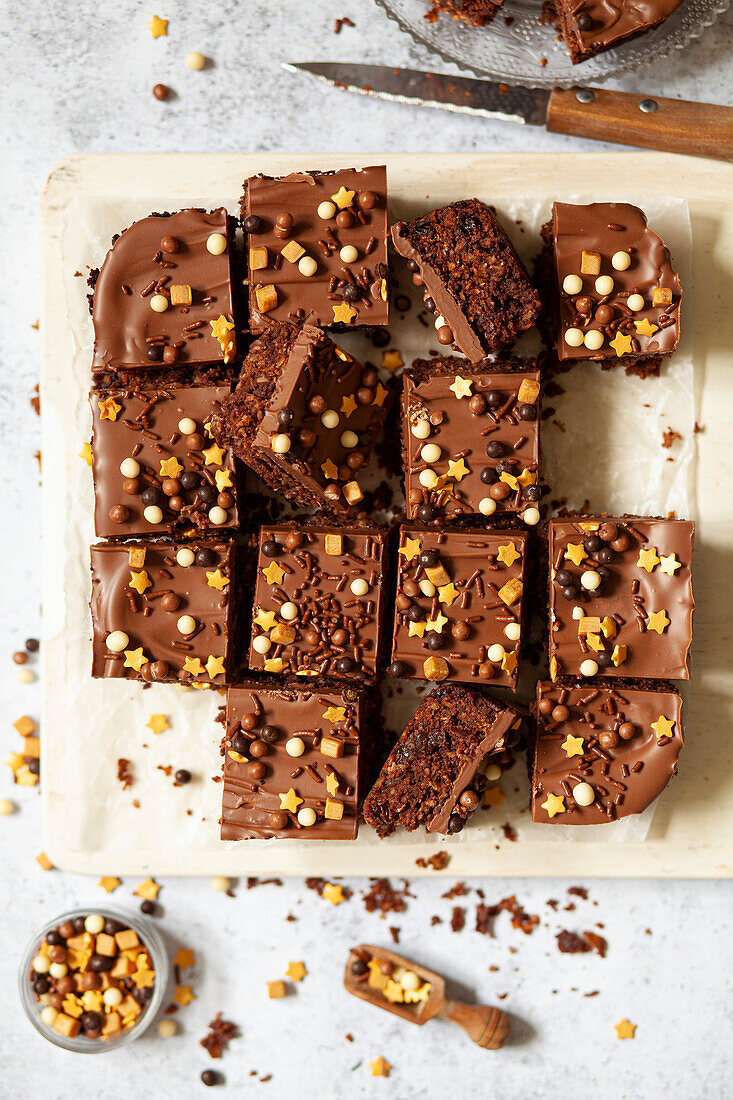 Australian crunchie (chocolate coconut squares) garnished with milk chocolate and mixed sprinkles