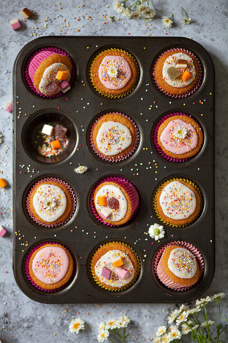 Fairy Cakes decorated with icing, sweets and love beads