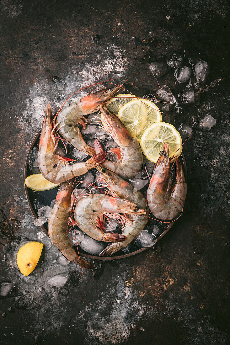 Fresh prawns on ice with lemon slices