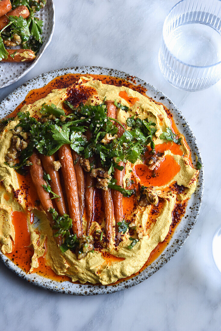 Roasted baby carrot salad with hummus and chili oil