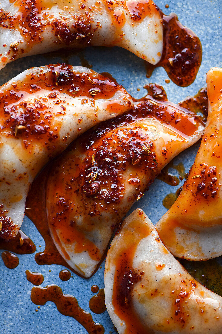 Filled dumplings topped with chili oil