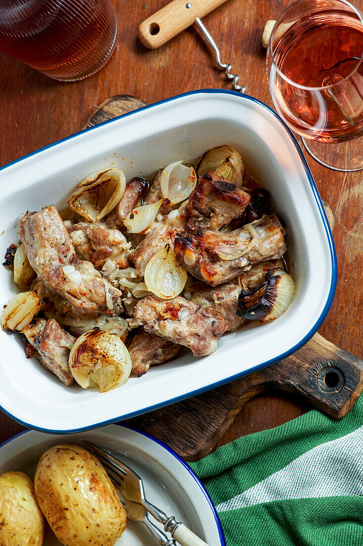 Oven-baked pork ribs with onions and potatoes