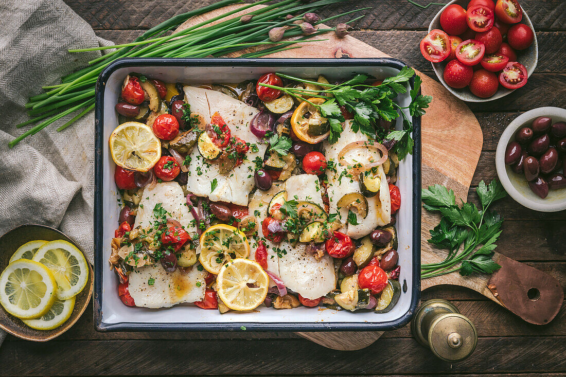 Gebratene Fischfilets mit Tomaten, Zucchini, Oliven und Zitrone