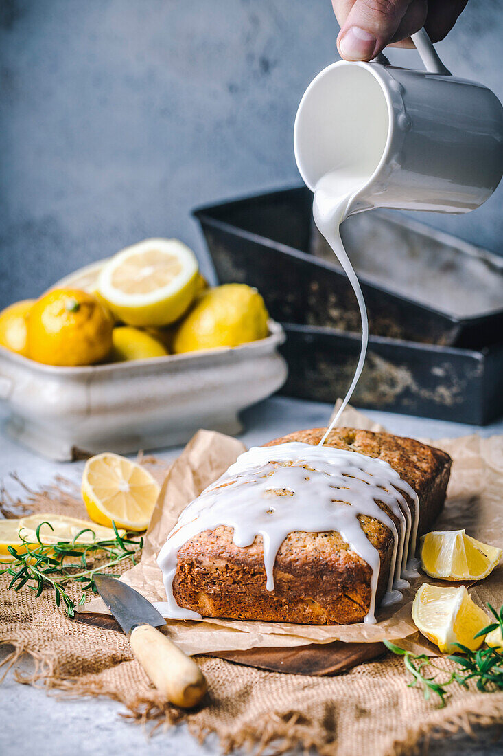 Pouring icing on lemon poppy seed cake