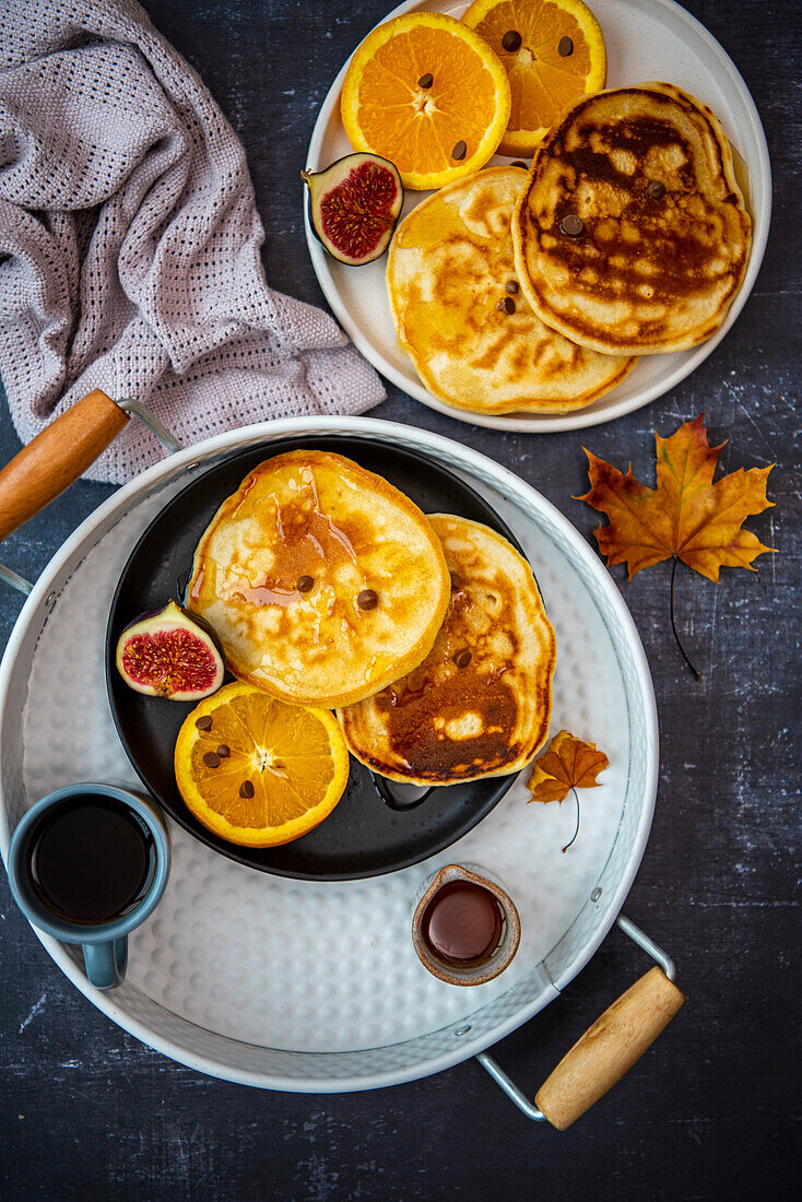 Almond milk pancakes served with orange slices, figs and chocolate chips