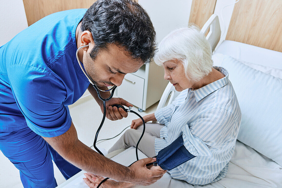 Checking patient's blood pressure