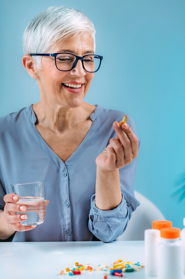 Senior woman taking dietary supplement