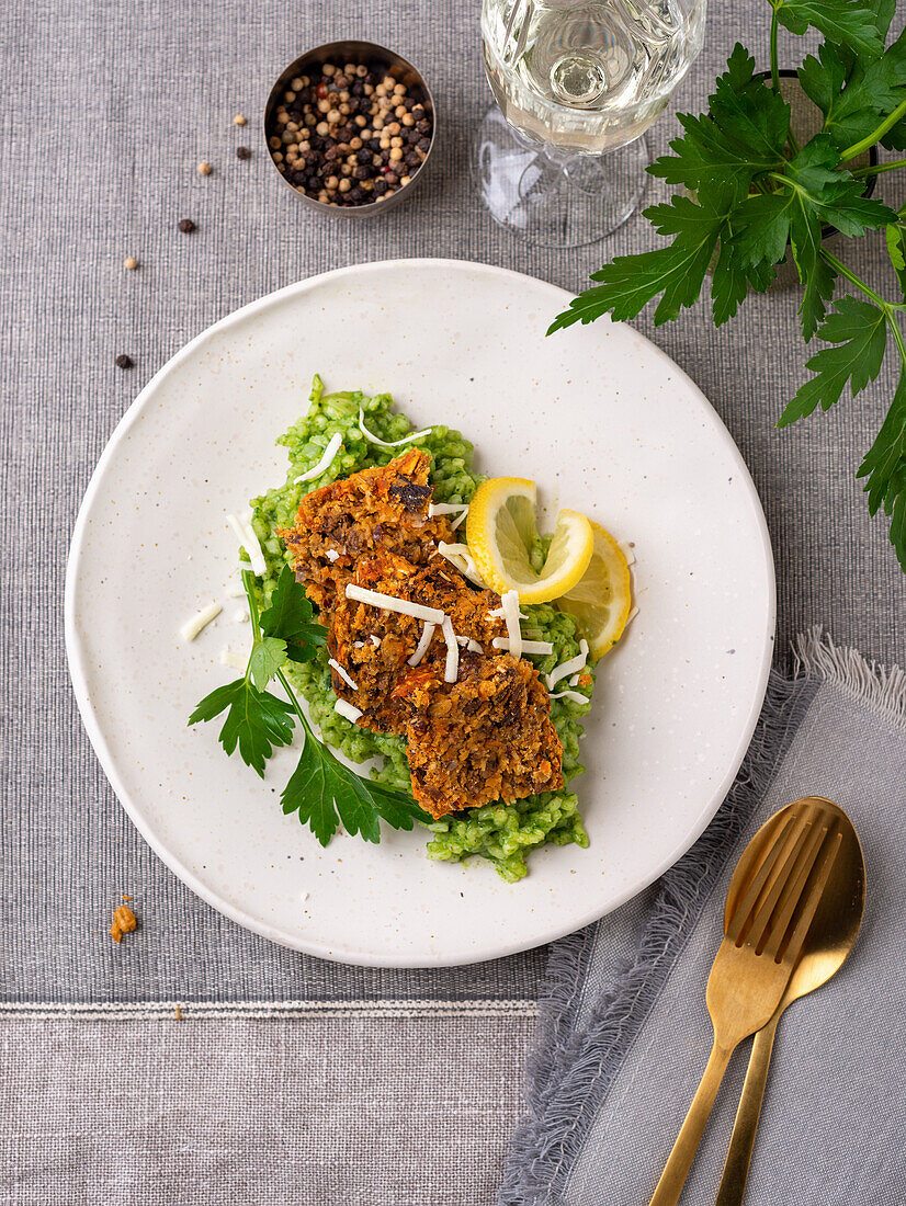 Vegan lentil roast on spinach risotto