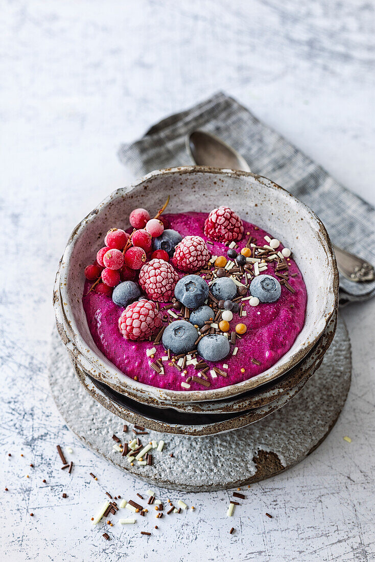 Dragon fruit smoothie bowl with banana, apple, oatmeal and berries