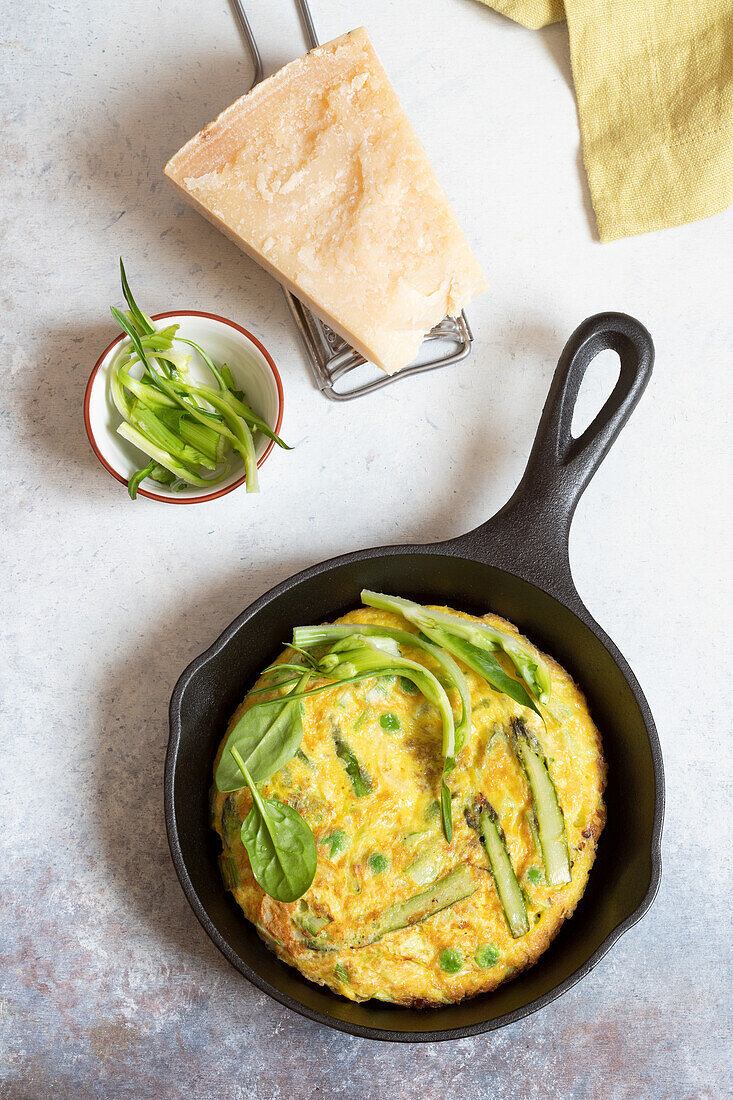 Omelette with asparagus, spring onions and peas