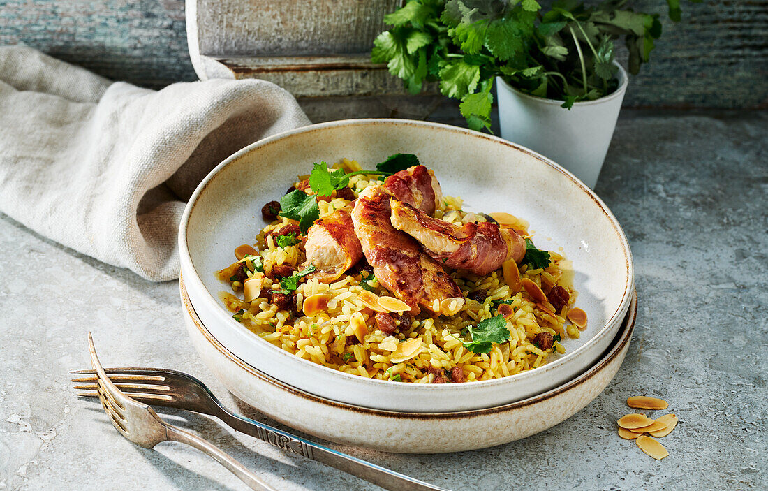 Turkey wrapped in bacon on saffron rice