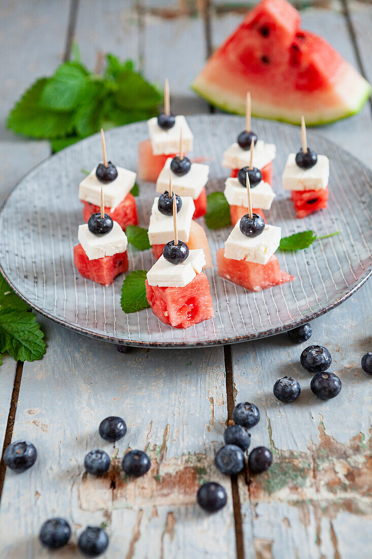 Bites with watermelon, feta, blueberries and mint