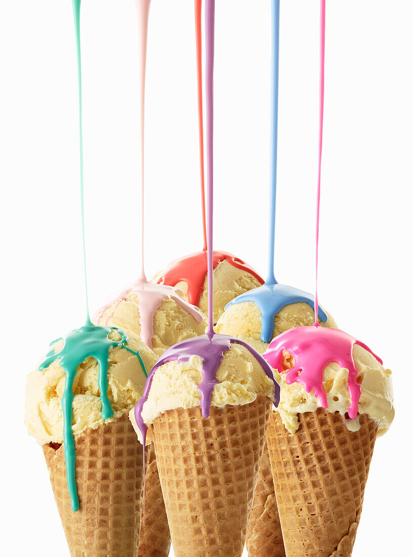 Vanilla ice cream with colorful sauce in waffle cones