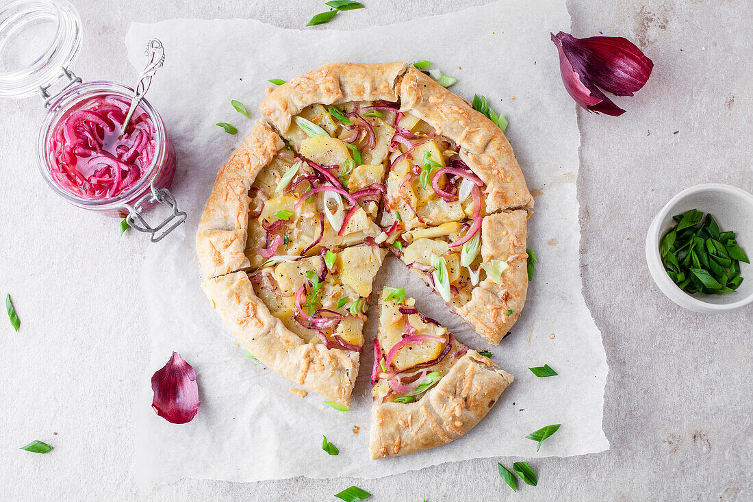 Potato galette with pickled red onions and green spring onions