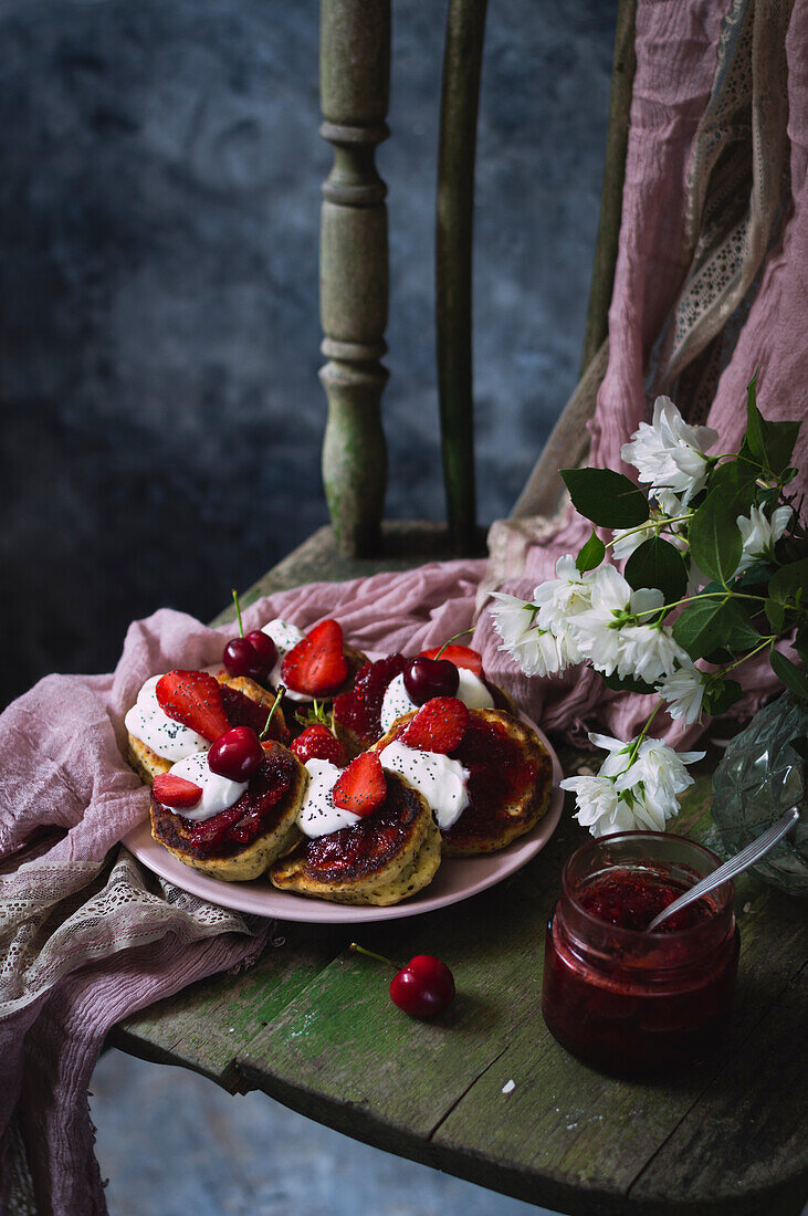 Poppy seed pancakes with cherries, strawberries, and yogurt