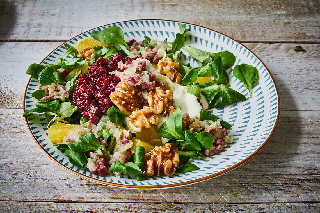 Lamb's lettuce with beet mousse, orange fillets, and walnuts