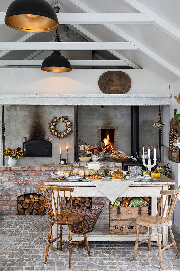 Set dining table in front of a rustic country-style stove