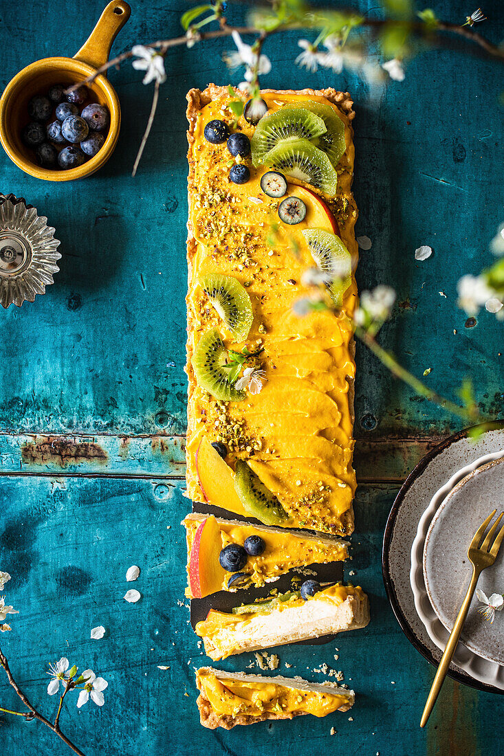 Mango mousse cake decorated with fresh fruit