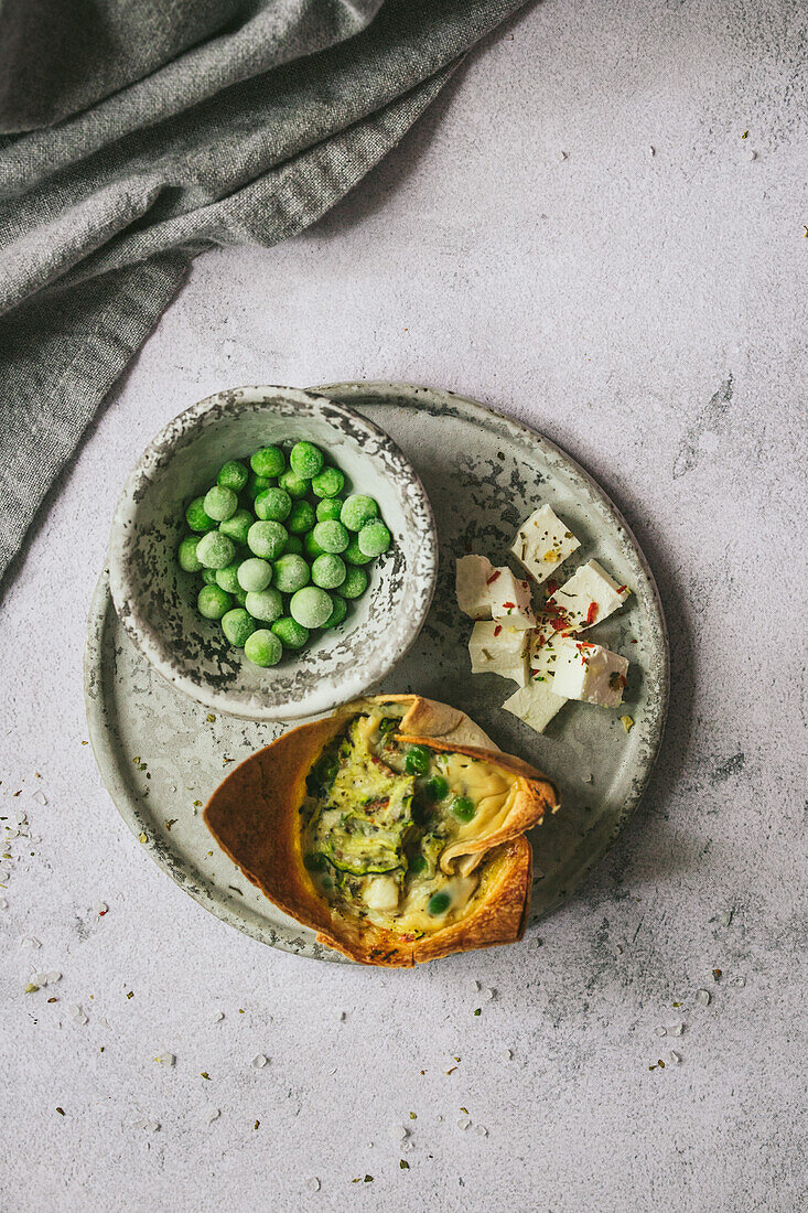 Tortilla breakfast cup with feta and peas