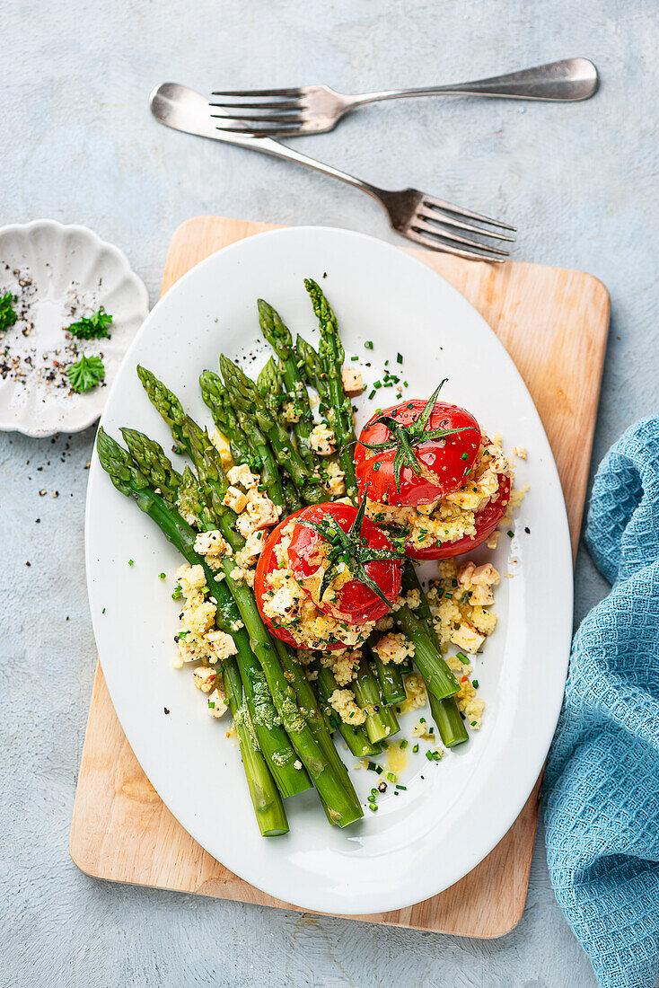 Couscous stuffed tomatoes with green asparagus