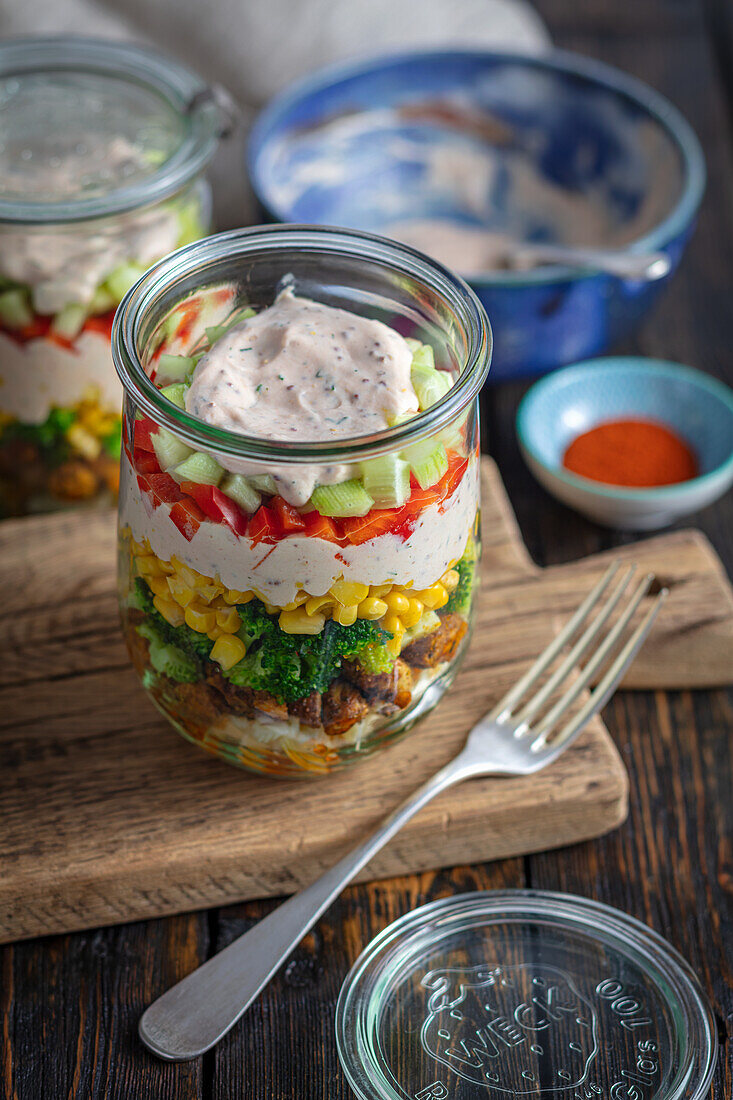 Layered salad with chicken, broccoli, noodles and corn