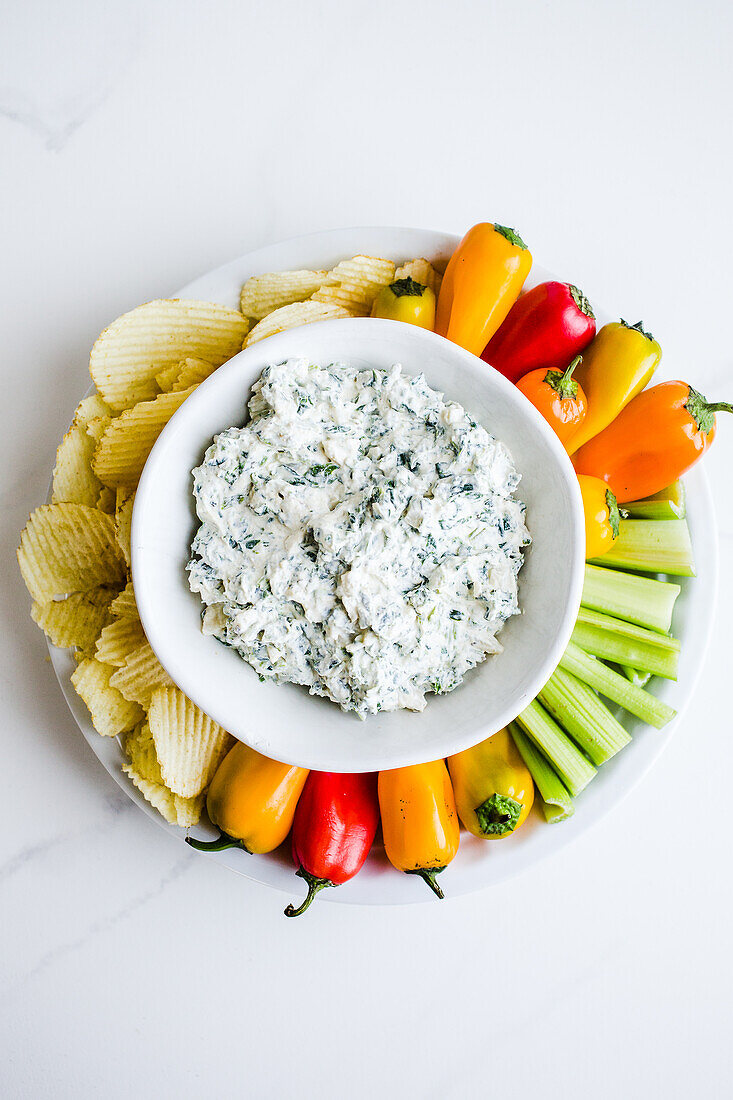 Spinach dip with vegetables and chips
