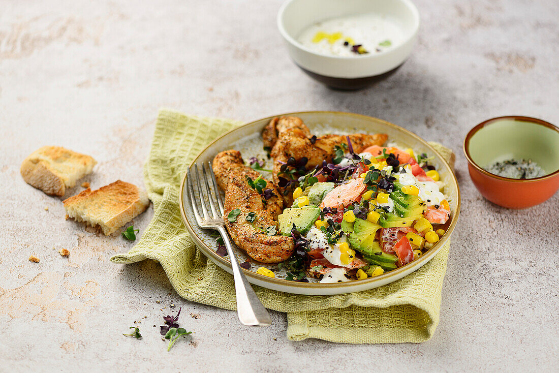 Spicy chicken fillets with avocado-corn salad