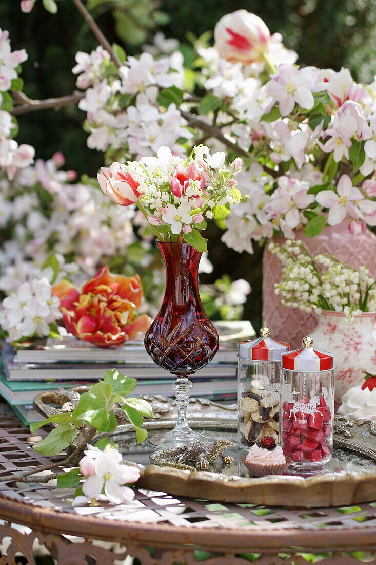 Small bouquet of apple blossoms, tulips and lily of the valley