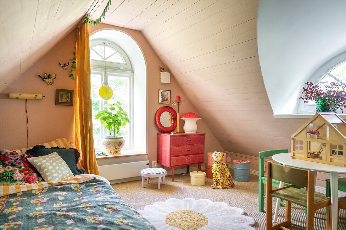 Attic room with play area and plants by the window