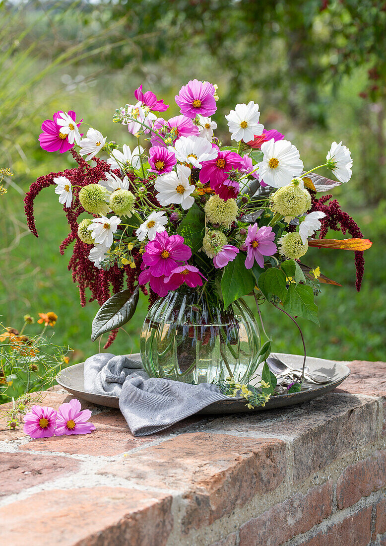 Bouquet of coneflower 'Delicous Nougat' (Echinacea), cosmea (Cosmos), foxtail (Amaranthus), roses 'Double Delight' (Rosa), broccoli on garden wall