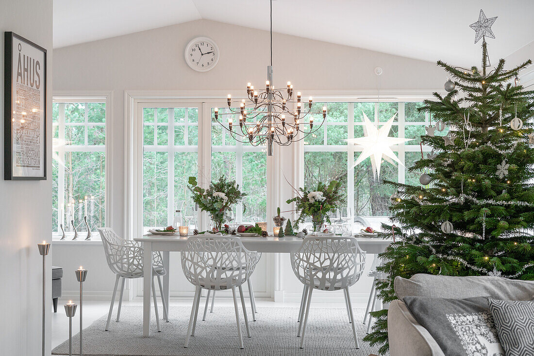 Dining table set for Christmas and decorated tree