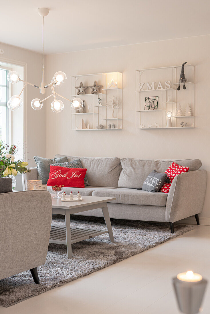 Living room decorated for Christmas with modern couch and decorative cushions