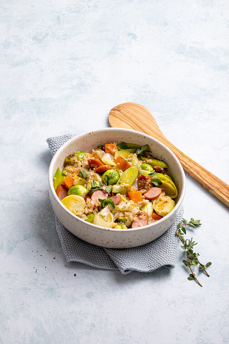 Brussels sprouts stew with porridge and sausages