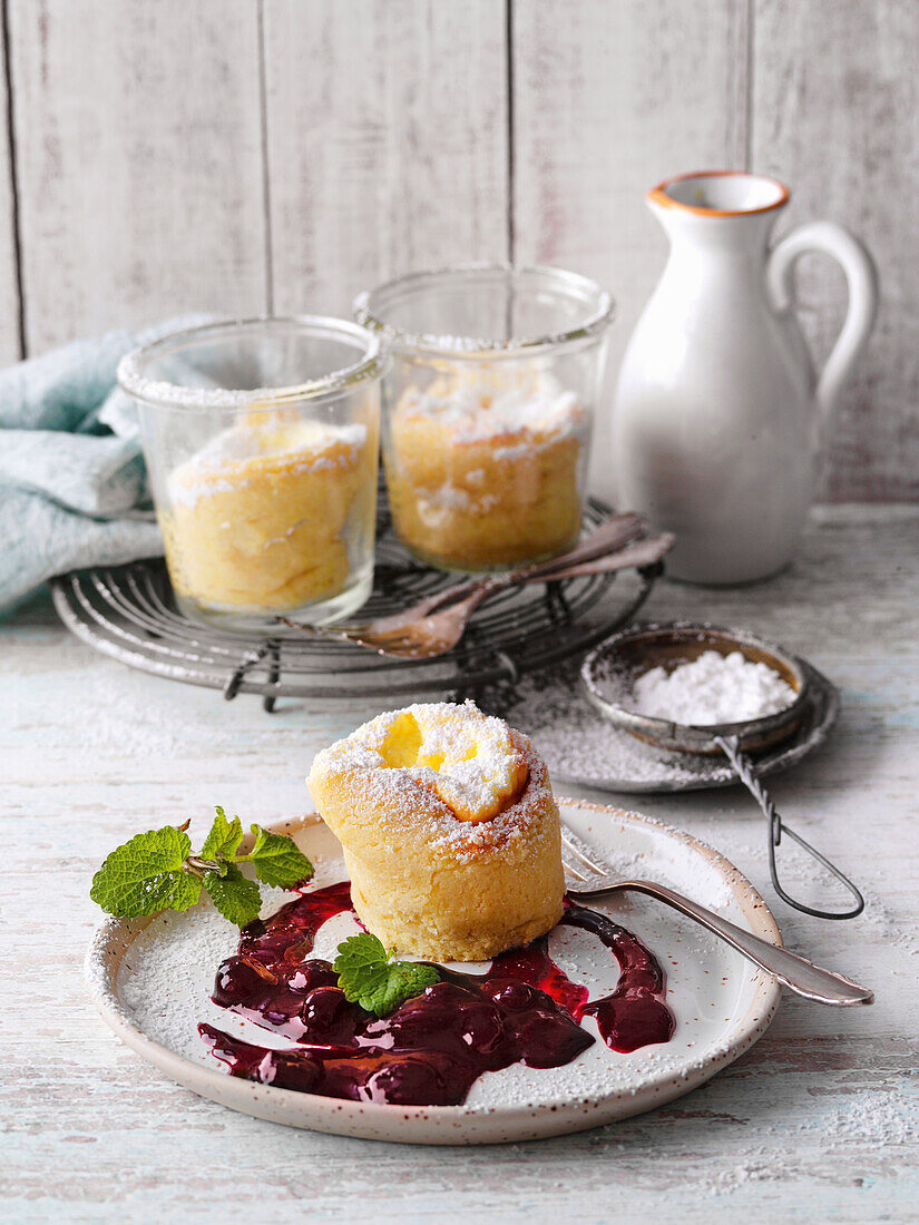 Cheesecake souffles cooked in jars with berry compote