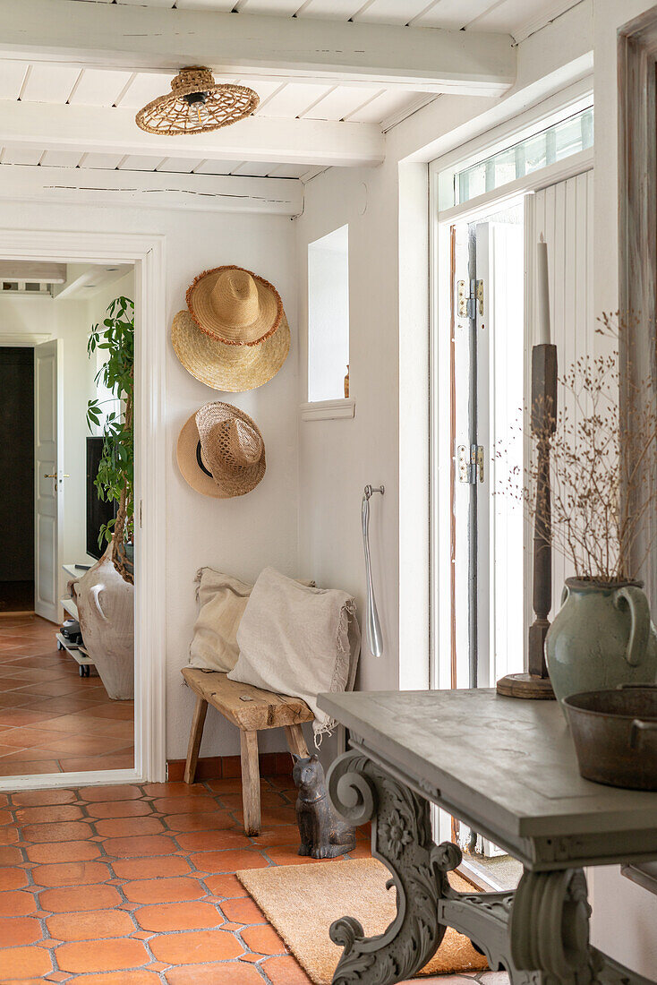 Country-style hallway with terracotta tiles and white wooden ceiling