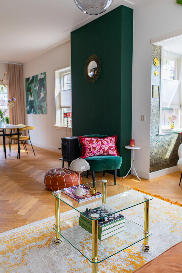 Living room with green accent wall and glass coffee table