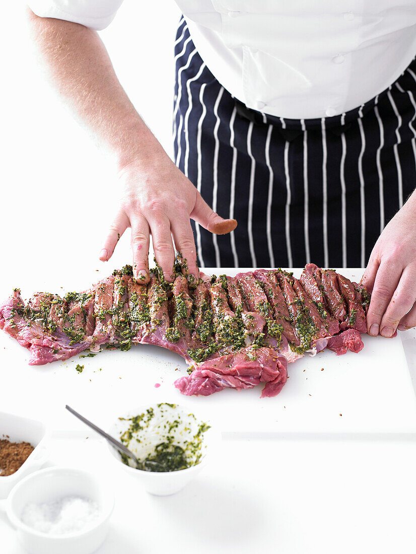 Preparing a Slow-cooked leg of lamb with kofta spices, pickled cucumber and pepper yogurt