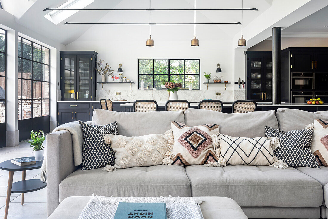 Modern living room with open-plan kitchen and window front