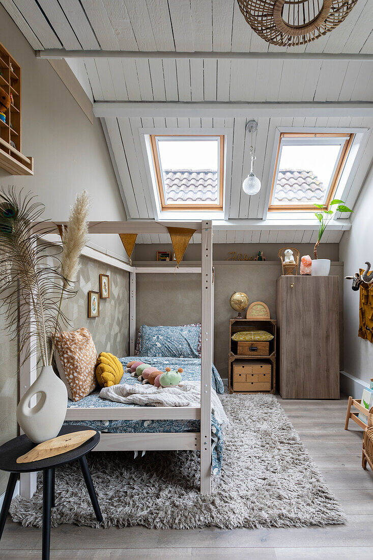 Children's room with sloping ceiling, bed, fluffy carpet and skylights