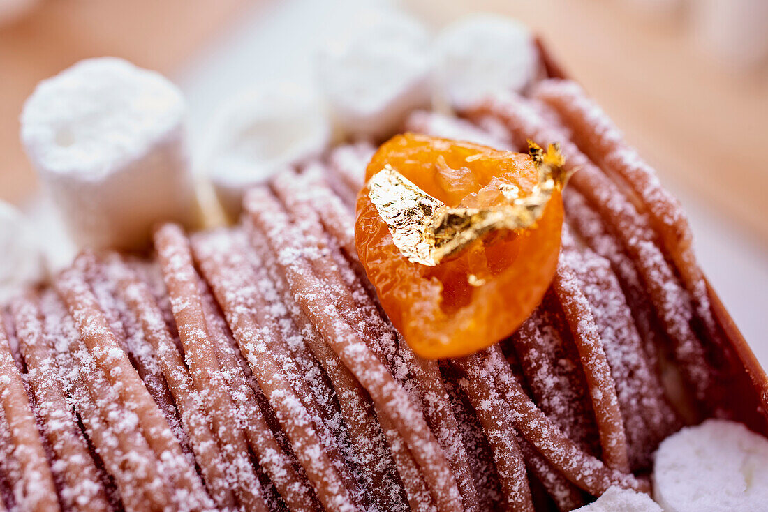 Chestnut cream with meringue, kumquat and gold leaf