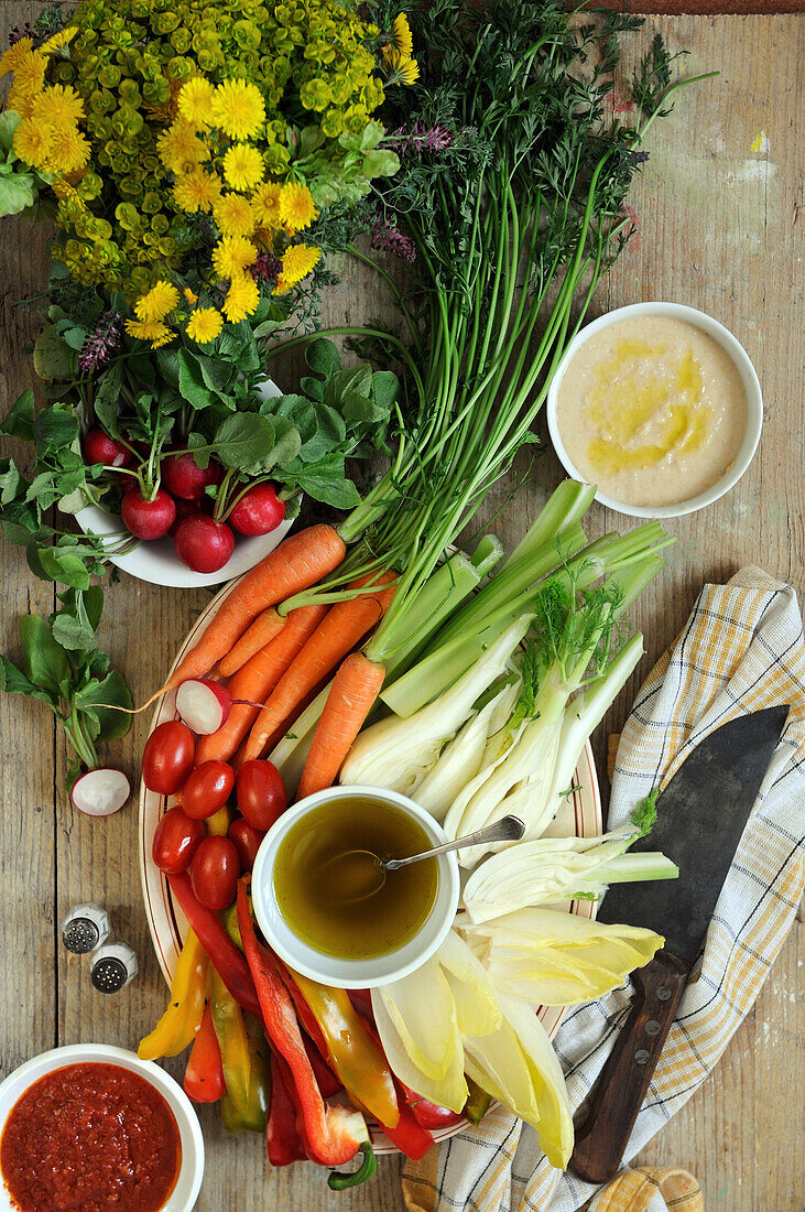 Pinzimonio (fresh vegetables) with tomato dip, olive oil and chickpea dip