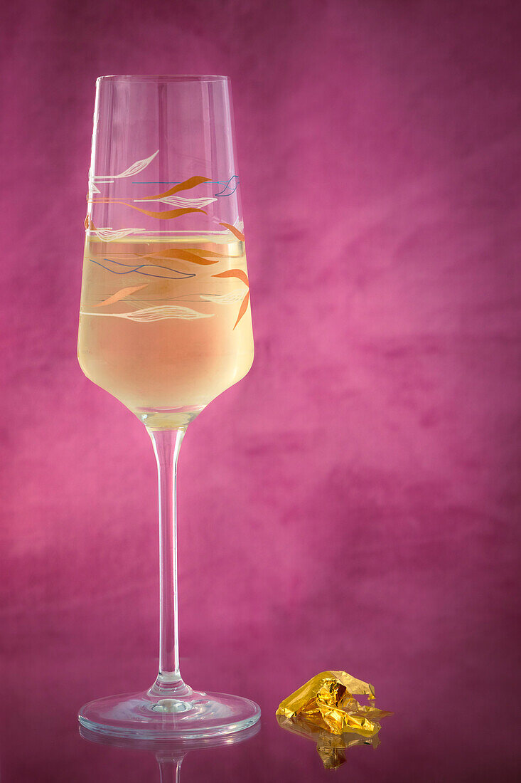 Champagne glass with sparkling wine and gold leaf