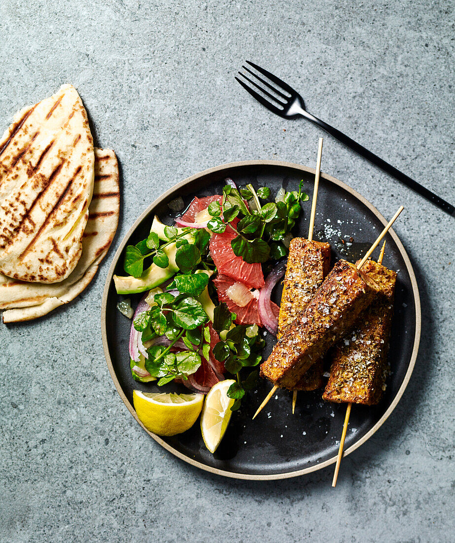Spiced salmon skewers with citrus and avocado salad