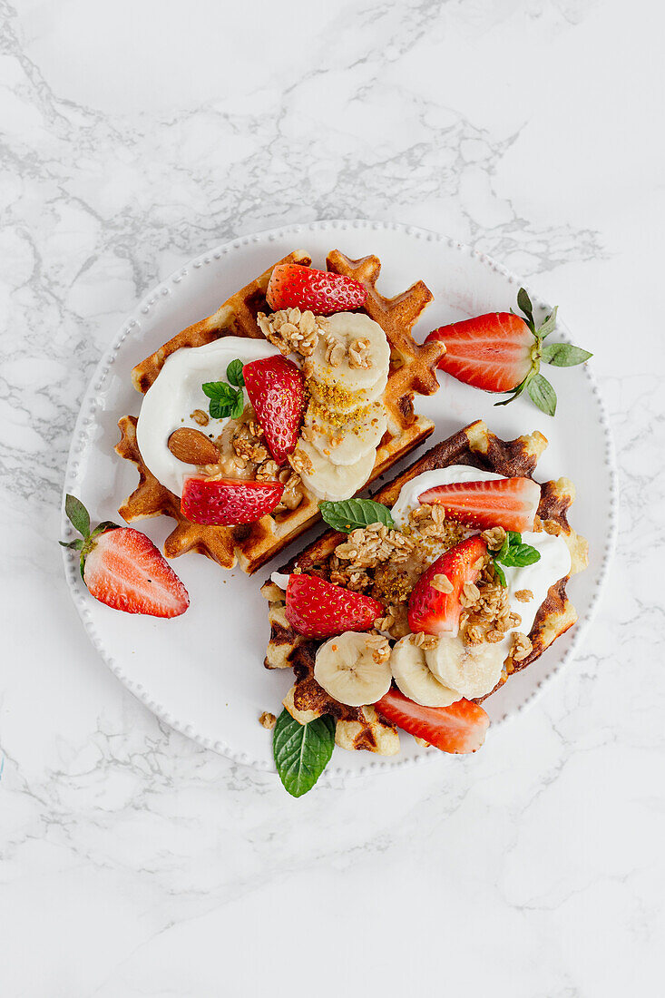 Waffles with strawberries, bananas, yogurt and muesli